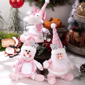 Pink and white Christmas plush ornaments with sequins on festive decorative background