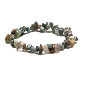 Detail of handmade bohemian bracelet featuring irregular natural colorful quartz stones