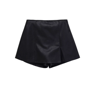 Detail view of high-waisted black faux leather skort featuring a side slit design