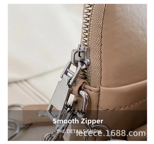 Detailed close-up of smooth silver zipper and stitching on cute bear PU leather bag