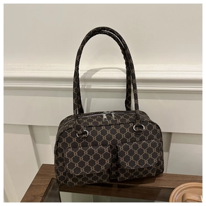 Detail of vintage monogram shoulder bag featuring dual front pockets and silver zippers