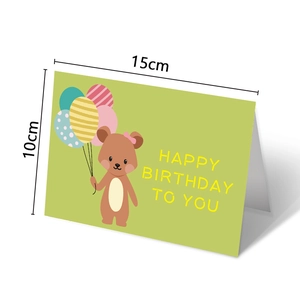 Detail showing folded green birthday card with cartoon bear and 15x10cm size specs