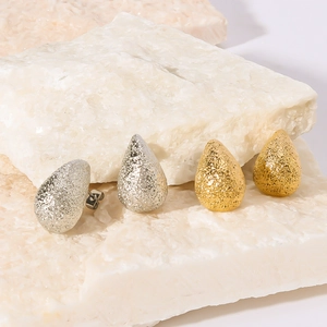 Hollow oval teardrop earrings in gold and silver finish with matte frosted texture