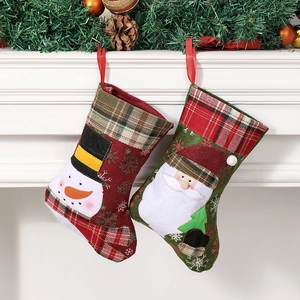 Christmas stockings featuring snowman and Santa Claus designs with festive plaid trim