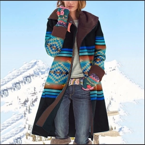 Women's long hooded coat with southwestern print and fur collar in snowy mountains