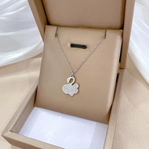 Minimalist titanium steel swan pendant necklace with floral texture in jewelry box