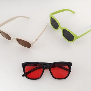 Retro square kids sunglasses in ivory, green and black colors on a white background