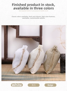 Detailed macro view of natural linen drawstring jewelry pouches with heart decor