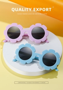 Detail of flower-shaped kids sunglasses in matte lavender and sky blue on a pedestal