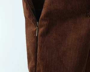Macro shot of invisible zipper and texture on caramel corduroy mini skirt detail