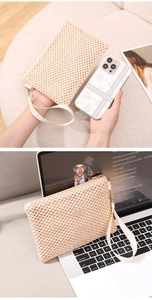 Detailed close-up of cream woven straw wristlet bag with zipper and hand strap