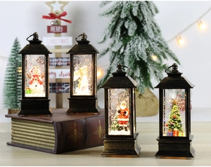 Detail of four vintage bronze Christmas lanterns with Santa, Snowman and Angel scenes
