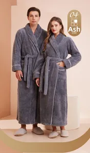 Close-up of thick dark grey fleece bathrobe showing soft texture and white piping details