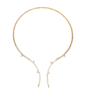 Golden open collar necklace with rhinestone thorns on a minimalist white background