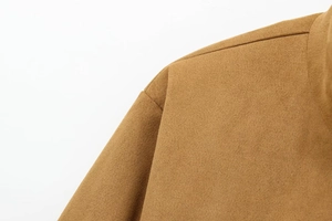 Close-up of the shoulder stitching and soft suede texture on a camel jacket