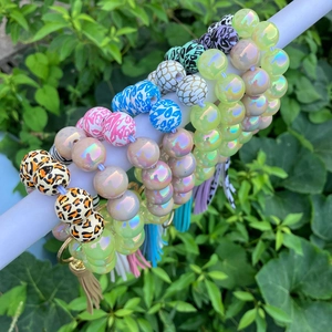 Close-up of leopard print and luminous beads keychain bracelet with golden tassels