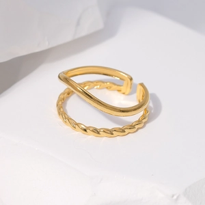 Detail of adjustable gold double-layer ring with smooth and twisted textures on stone