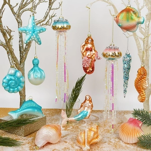 Ocean-themed Christmas glass ornaments featuring mermaid and sea creatures on white tree