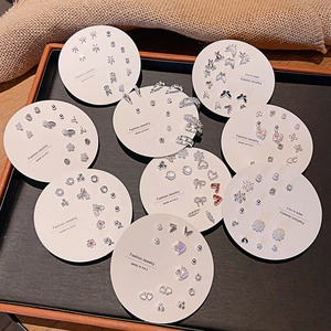 Flat lay of multiple silver and gold stud earring sets with pearls and crystals