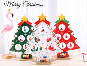 Close-up of three mini wooden Christmas trees in red green and white for desk decor