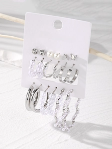 Detail of 12-piece silver earring set with butterfly, pearls and rhinestones on display