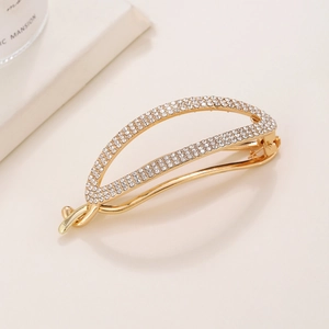Minimalist gold metal hair claw with sparkling crystals and twisted design for women