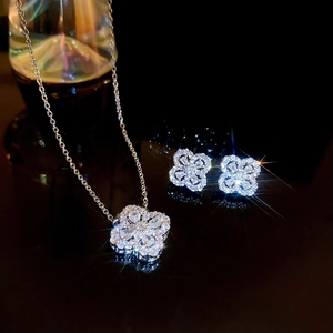 Macro view of silver clover jewelry set with sparkling crystals and starburst lighting