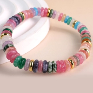Detailed macro shot of colorful semi-precious beads with gold spacers on the bracelet