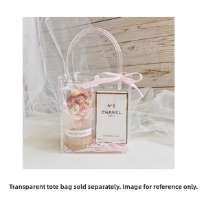 Detail of mini dried flower bouquet in gift box with pink ribbon and clear carrier bag