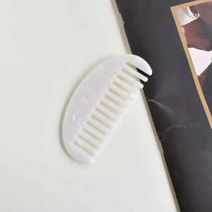 Elegant white crescent wide-tooth acetate hair comb with pearlescent marble finish
