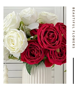 Artificial bouquet of white and red roses in a white ceramic vase for home decoration