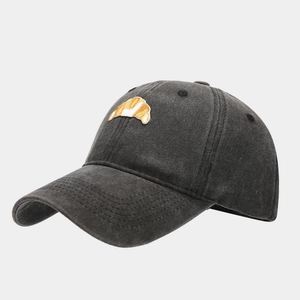 Close-up of vintage dark grey washed cotton baseball cap with croissant embroidery