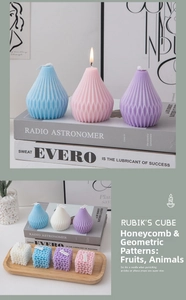 Detailed view of geometric pear-shaped and honeycomb-textured scented candles in Morandi tones