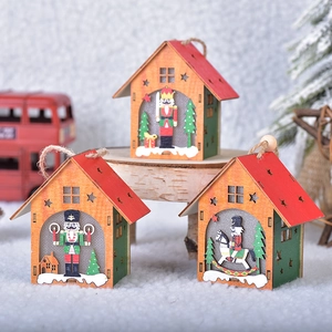 Three wooden nutcracker house ornaments with glowing stars for Christmas tree decor