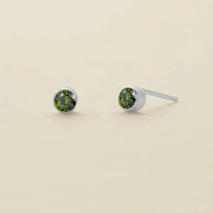 Minimalist silver stud earrings with round emerald green zircon in bezel setting