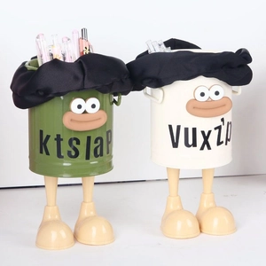 Desktop pen holder showing green and white creative designs with cartoon legs for office storage