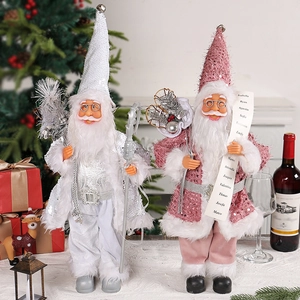 Standing Christmas Santa dolls in pink and silver sequins with fur trim and festive props