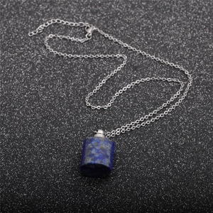 Silver stainless steel necklace featuring a blue cylindrical stone essential oil bottle pendant