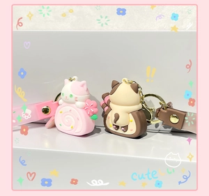 Detailed view of cute silicone cat cake roll keychains with matching hand straps