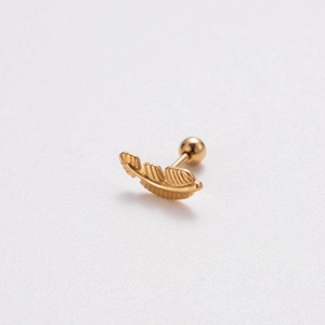Detail showing a golden feather stud earring made of metal with a round ball screw back