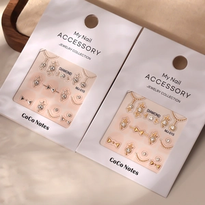 Stereo bronzing nail stickers set with crystals and metallic beads in white packaging