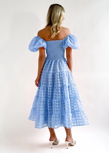 Detail of light blue tiered dress featuring puff sleeves and smocked back design