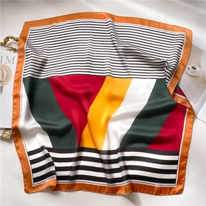 Satin silk scarf with geometric blocks and stripes, featuring a refined orange border edge