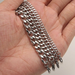 Classic silver stainless steel Cuban link bracelet for men shown on palm to show size