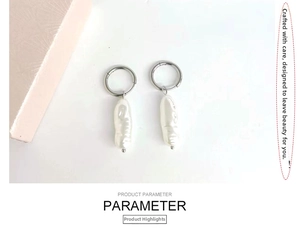Detailed shot of C-shaped silver polished earrings with white baroque pearl drop