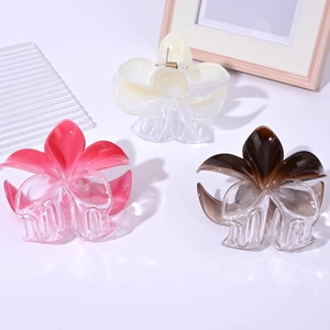 Three gradient frangipani hair claws in pink white and brown colors for women