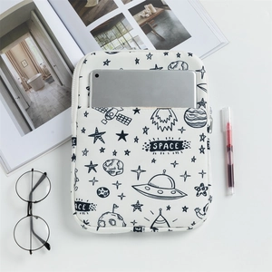 Detailed close-up of a white padded laptop sleeve with space-themed illustrations and zipper