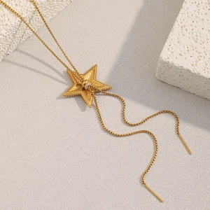 Detail of 18K gold plated star pendant necklace with adjustable sliding bead and box chain