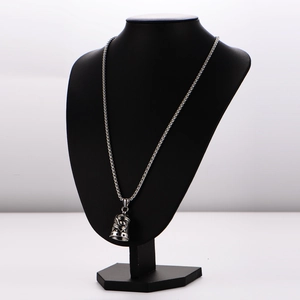 Detail of vintage eagle bell pendant with LIVE text on stainless steel curb chain