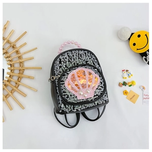 Close-up of black sequin kids backpack featuring a pink shell and pearl bead handle
